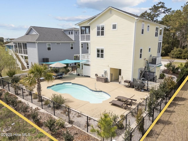 view of swimming pool featuring a patio area, outdoor dining space, fence, stairs, and a fenced in pool