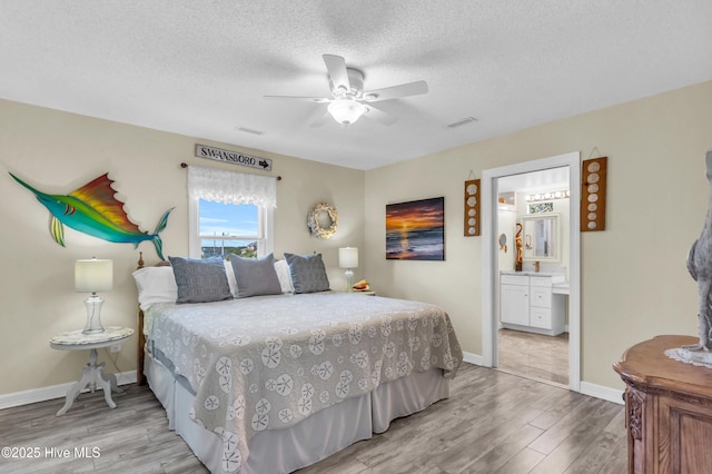 bedroom with visible vents, baseboards, a textured ceiling, a ceiling fan, and light wood finished floors