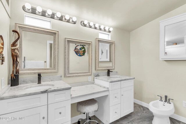 bathroom featuring vanity, baseboards, a bidet, and marble finish floor