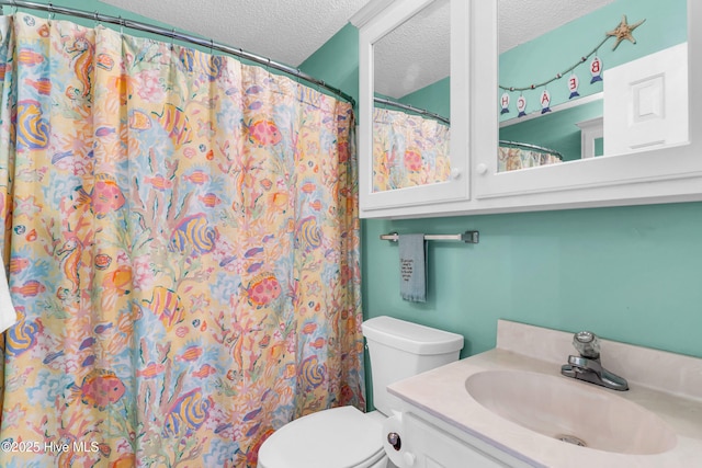 bathroom featuring toilet, a textured ceiling, a shower with curtain, and vanity