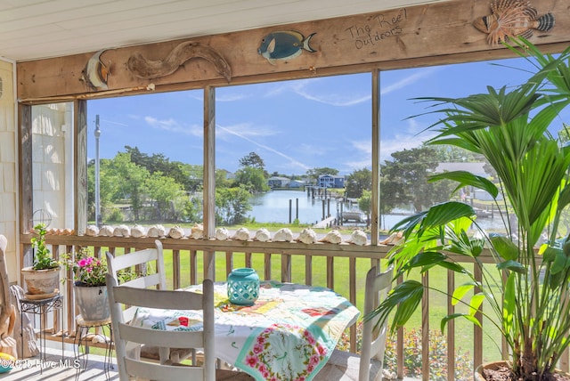 sunroom / solarium with a water view