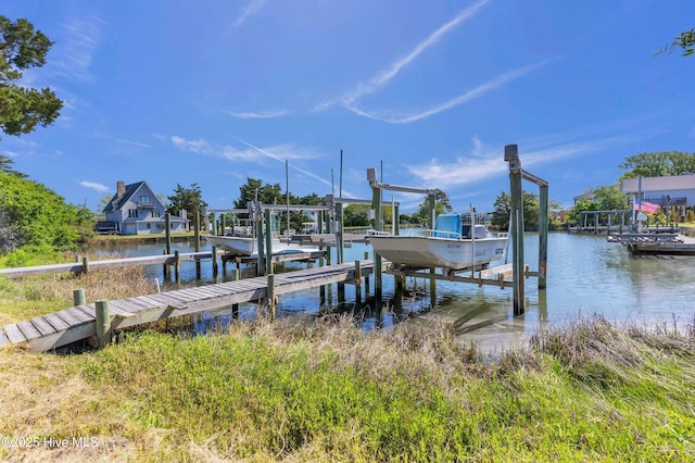 dock area featuring boat lift and a water view