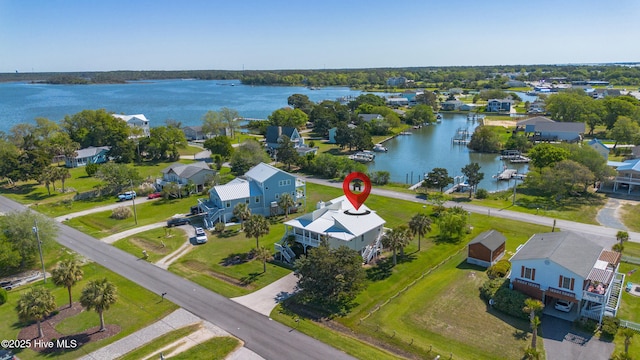 birds eye view of property with a water view and a residential view