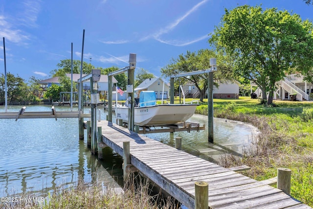 view of dock with a water view, boat lift, and a residential view