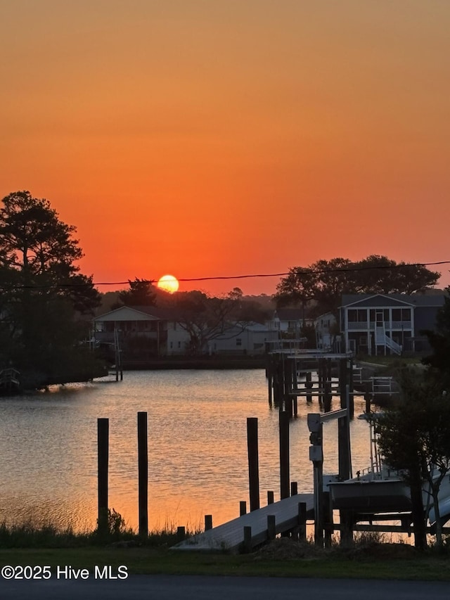 dock area with a water view and boat lift