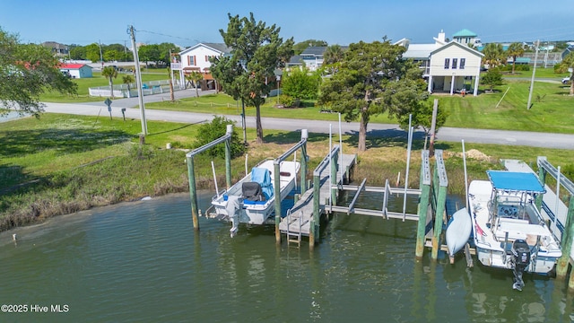 dock area featuring a yard and boat lift