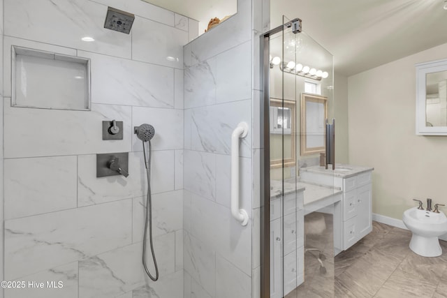 full bathroom with a tile shower, vanity, marble finish floor, baseboards, and a bidet