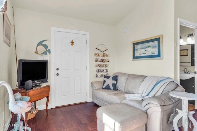 living area with baseboards and dark wood finished floors