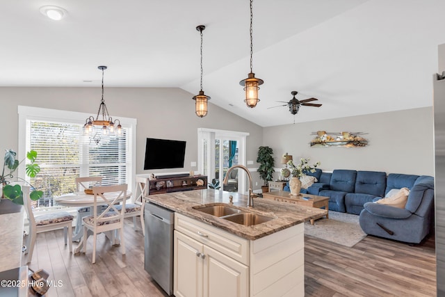 107 SW 25th St, Oak Island, NC 28465 - kitchen with stainless steel dishwasher, light wood-style floors, open floor plan, and a sink