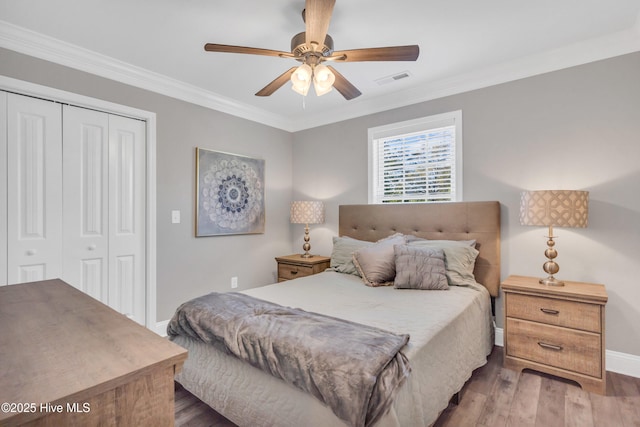 107 SW 25th St, Oak Island, NC 28465 - bedroom featuring baseboards, a closet, crown molding, and wood finished floors