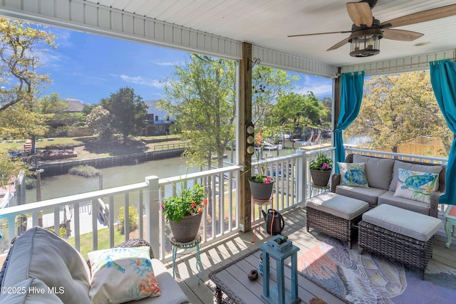 107 SW 25th St, Oak Island, NC 28465 - wooden deck with outdoor lounge area, a water view, and ceiling fan