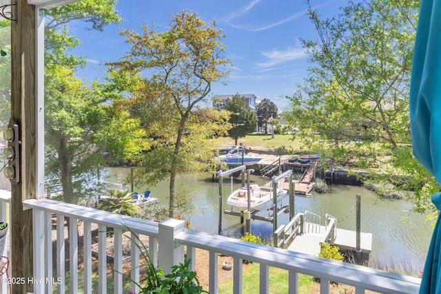 107 SW 25th St, Oak Island, NC 28465 - view of dock featuring boat lift and a water view