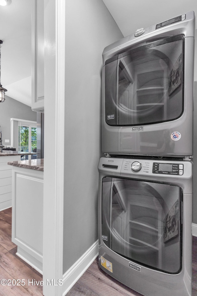 107 SW 25th St, Oak Island, NC 28465 - laundry area with laundry area, stacked washer and dryer, and wood finished floors