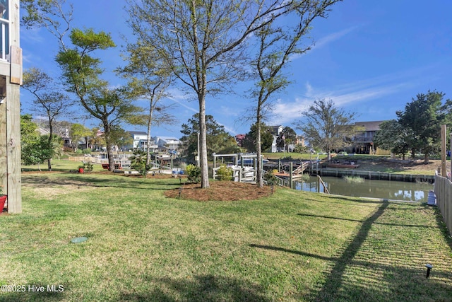 107 SW 25th St, Oak Island, NC 28465 - view of yard with a dock and a water view