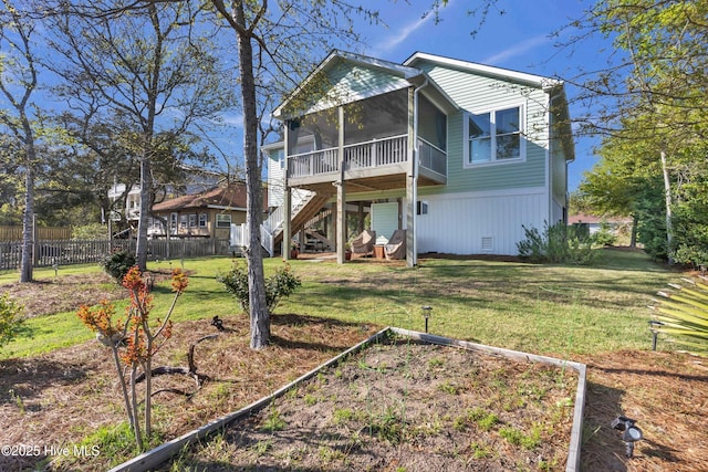 107 SW 25th St, Oak Island, NC 28465 - back of property featuring a yard, a sunroom, fence, and stairway