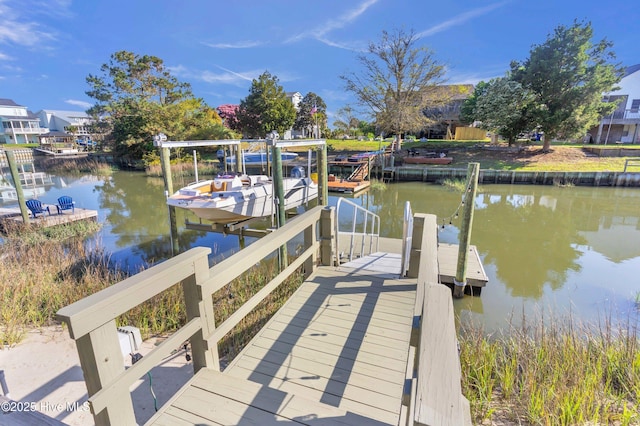 107 SW 25th St, Oak Island, NC 28465 - view of dock with boat lift and a water view