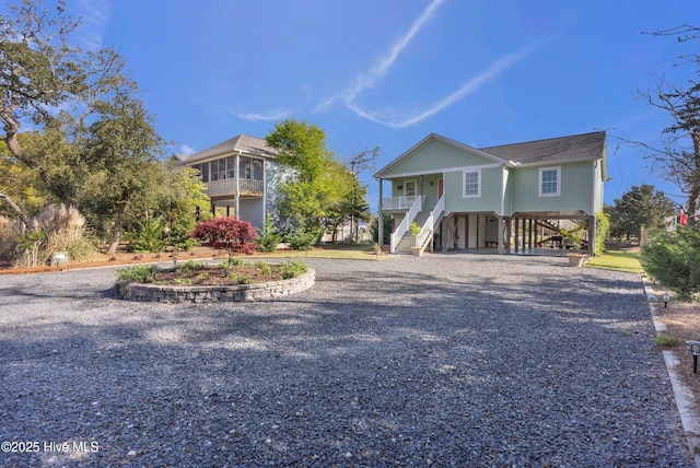 107 SW 25th St, Oak Island, NC 28465 - beach home with a porch, stairs, a carport, and driveway