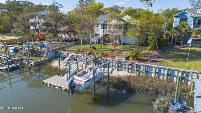 107 SW 25th St, Oak Island, NC 28465 - dock area featuring a yard, stairs, and a deck with water view