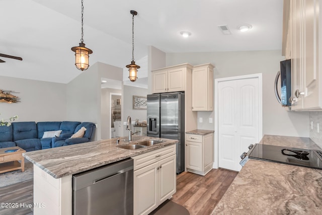 107 SW 25th St, Oak Island, NC 28465 - kitchen featuring dark wood-style flooring, hanging light fixtures, a sink, open floor plan, and stainless steel appliances