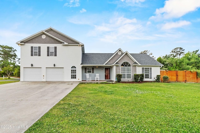 traditional-style home with a front lawn, a garage, covered porch, concrete driveway, and fence