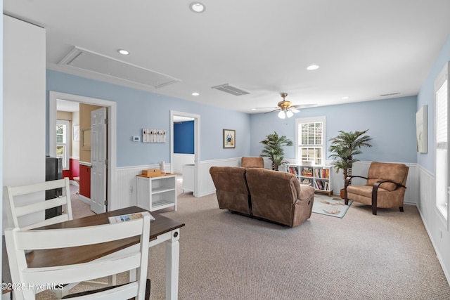 living room featuring attic access, recessed lighting, carpet flooring, a wainscoted wall, and visible vents