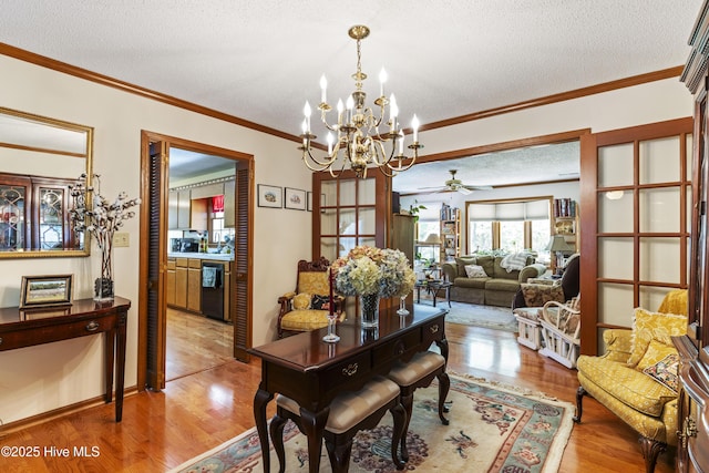 dining space featuring ceiling fan with notable chandelier, a textured ceiling, light wood-style floors, and ornamental molding