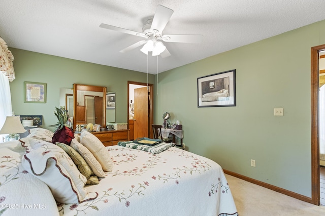 bedroom featuring baseboards, light colored carpet, and ceiling fan