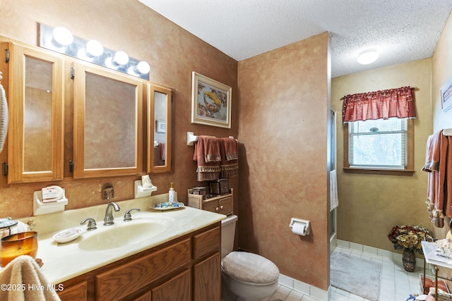 bathroom with a shower stall, tile patterned floors, toilet, vanity, and a textured ceiling
