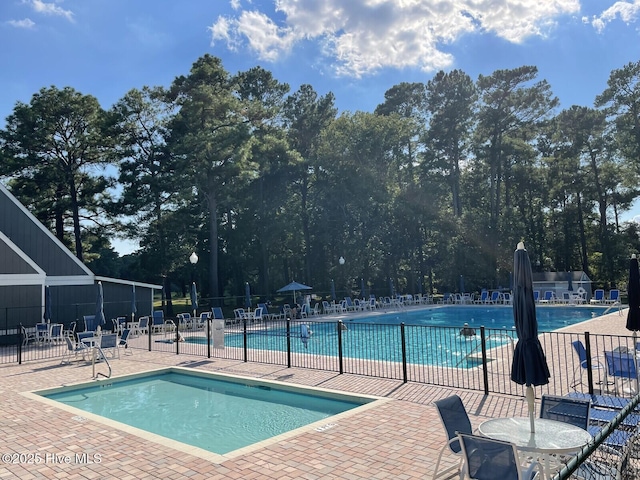 pool featuring a patio area and fence
