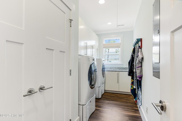 117 NW 2nd St, Oak Island, NC 28465 - laundry area with recessed lighting, dark wood-style flooring, washing machine and clothes dryer, and cabinet space