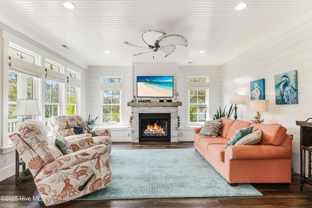 117 NW 2nd St, Oak Island, NC 28465 - living room featuring ceiling fan, recessed lighting, a glass covered fireplace, and wood finished floors