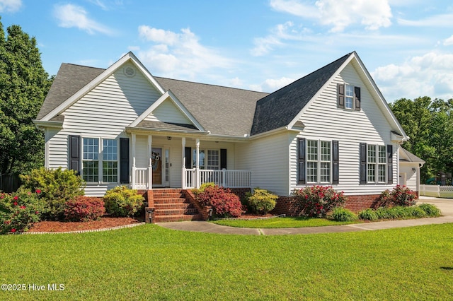 view of front of home featuring a porch, a front yard, and roof with shingles