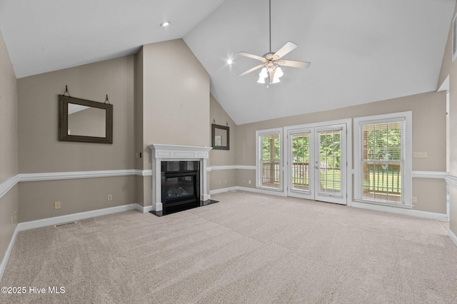 unfurnished living room featuring a high end fireplace, baseboards, carpet, and a ceiling fan