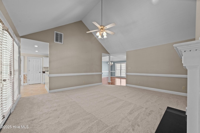 unfurnished living room featuring ceiling fan, light colored carpet, visible vents, high vaulted ceiling, and baseboards