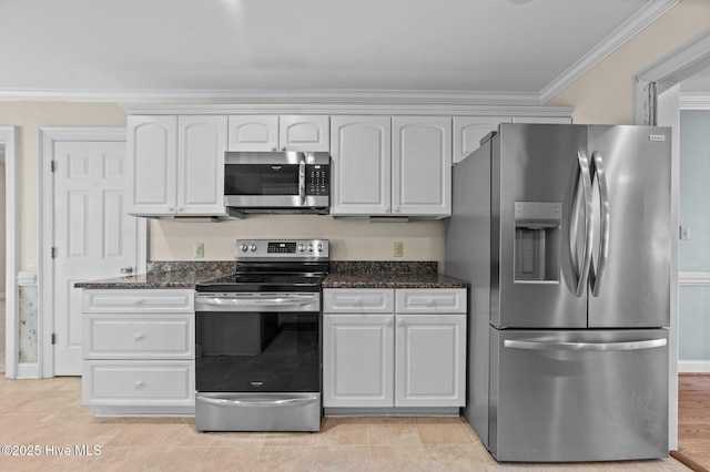 kitchen with crown molding, stainless steel appliances, white cabinets, and dark stone countertops