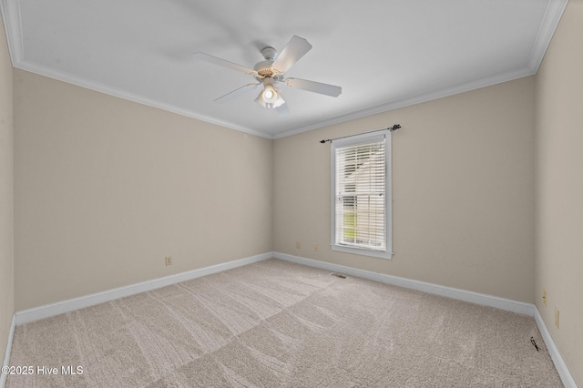 empty room with baseboards, ornamental molding, light carpet, and a ceiling fan