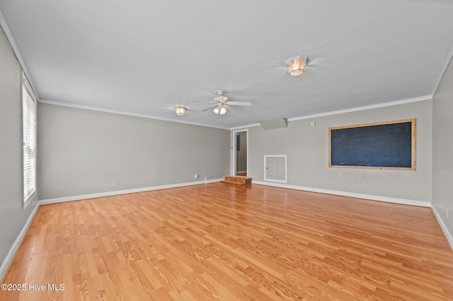 unfurnished living room with baseboards, ceiling fan, ornamental molding, and wood finished floors