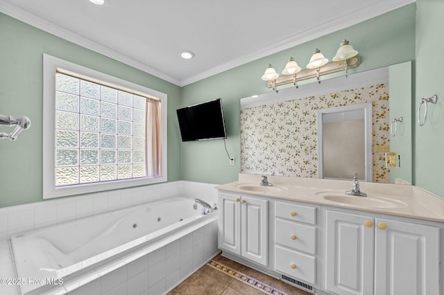 full bathroom featuring crown molding, a sink, tile patterned flooring, and a jetted tub