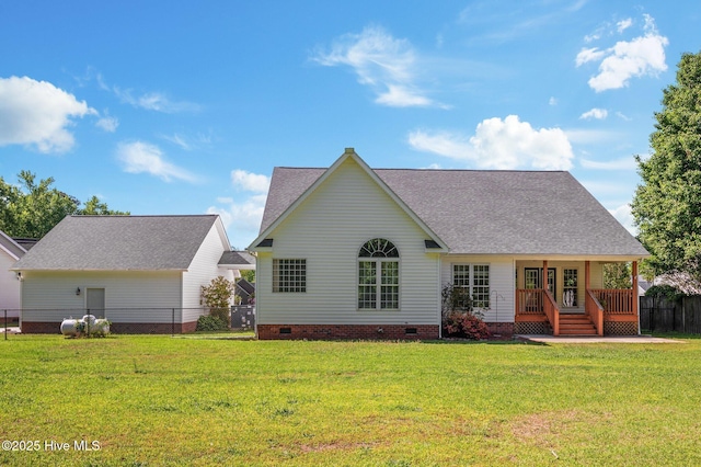 back of property with a lawn, roof with shingles, and crawl space