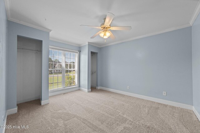 unfurnished bedroom with crown molding, baseboards, ceiling fan, and carpet flooring