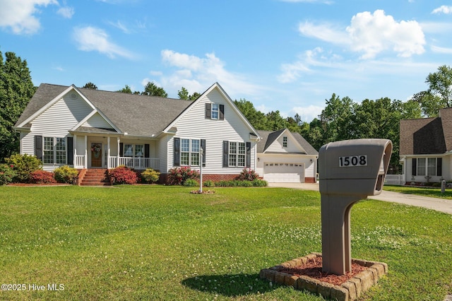 view of front of house with a shingled roof, a front lawn, a garage, a porch, and driveway
