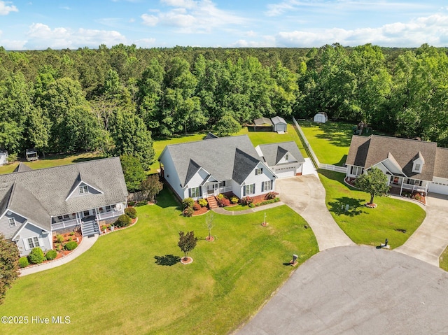 drone / aerial view with a wooded view