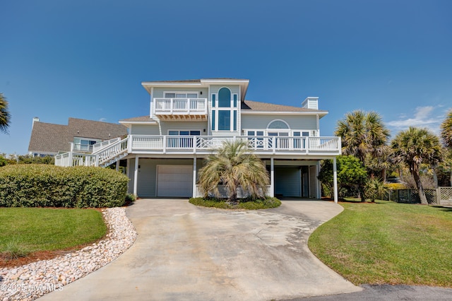 view of front facade with a carport, concrete driveway, a balcony, and a front lawn
