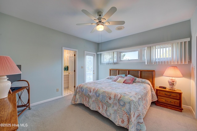 carpeted bedroom with ensuite bathroom, ceiling fan, and baseboards