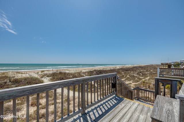 wooden terrace with a beach view and a water view