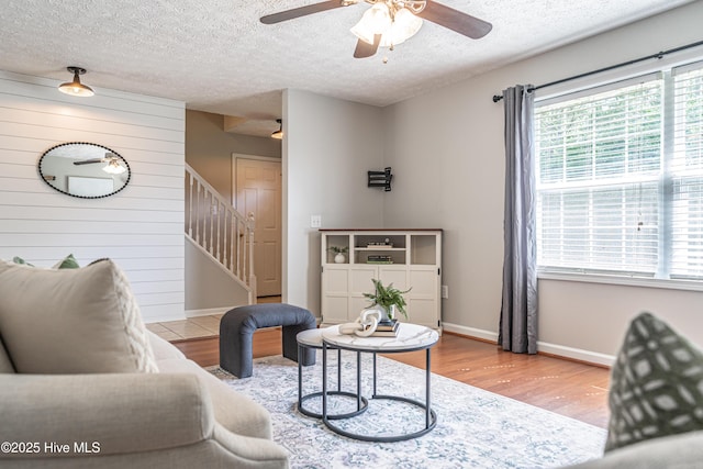 4915 Beulah Hill Church Rd, West End, NC 27376 - living room featuring wood finished floors, stairs, a ceiling fan, baseboards, and a textured ceiling