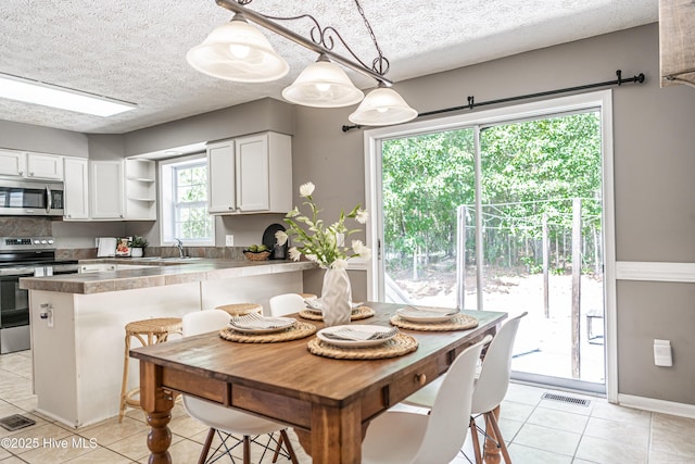 4915 Beulah Hill Church Rd, West End, NC 27376 - dining area featuring light tile patterned floors and a textured ceiling