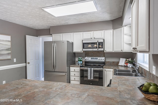 4915 Beulah Hill Church Rd, West End, NC 27376 - kitchen featuring appliances with stainless steel finishes, a sink, a textured ceiling, open shelves, and white cabinetry