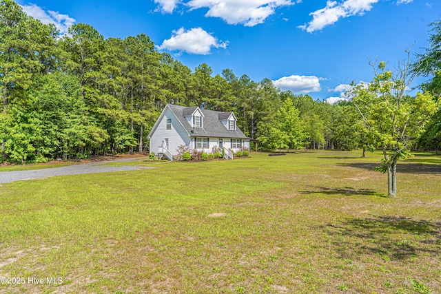 4915 Beulah Hill Church Rd, West End, NC 27376 - new england style home with a front yard and a wooded view