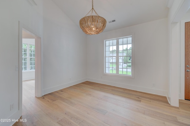 226 Bayfield Dr, Wilmington, NC 28411 - spare room featuring a chandelier, light wood finished floors, and vaulted ceiling